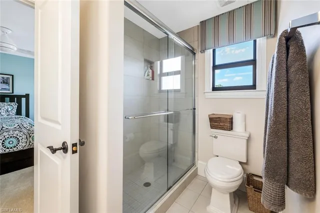 a bathroom with a toilet and a shower