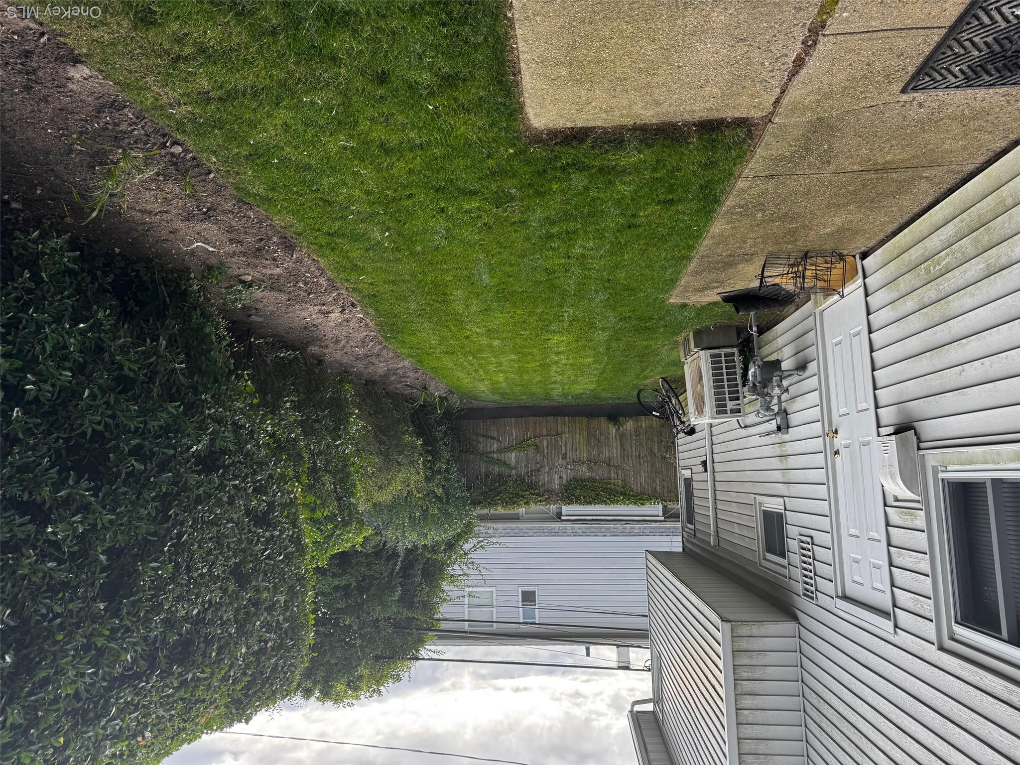 113 Maple Boulevard, Unit UPPR Long Beach, NY 11561 - Photo 11 of 11 a view of a back yard of the house