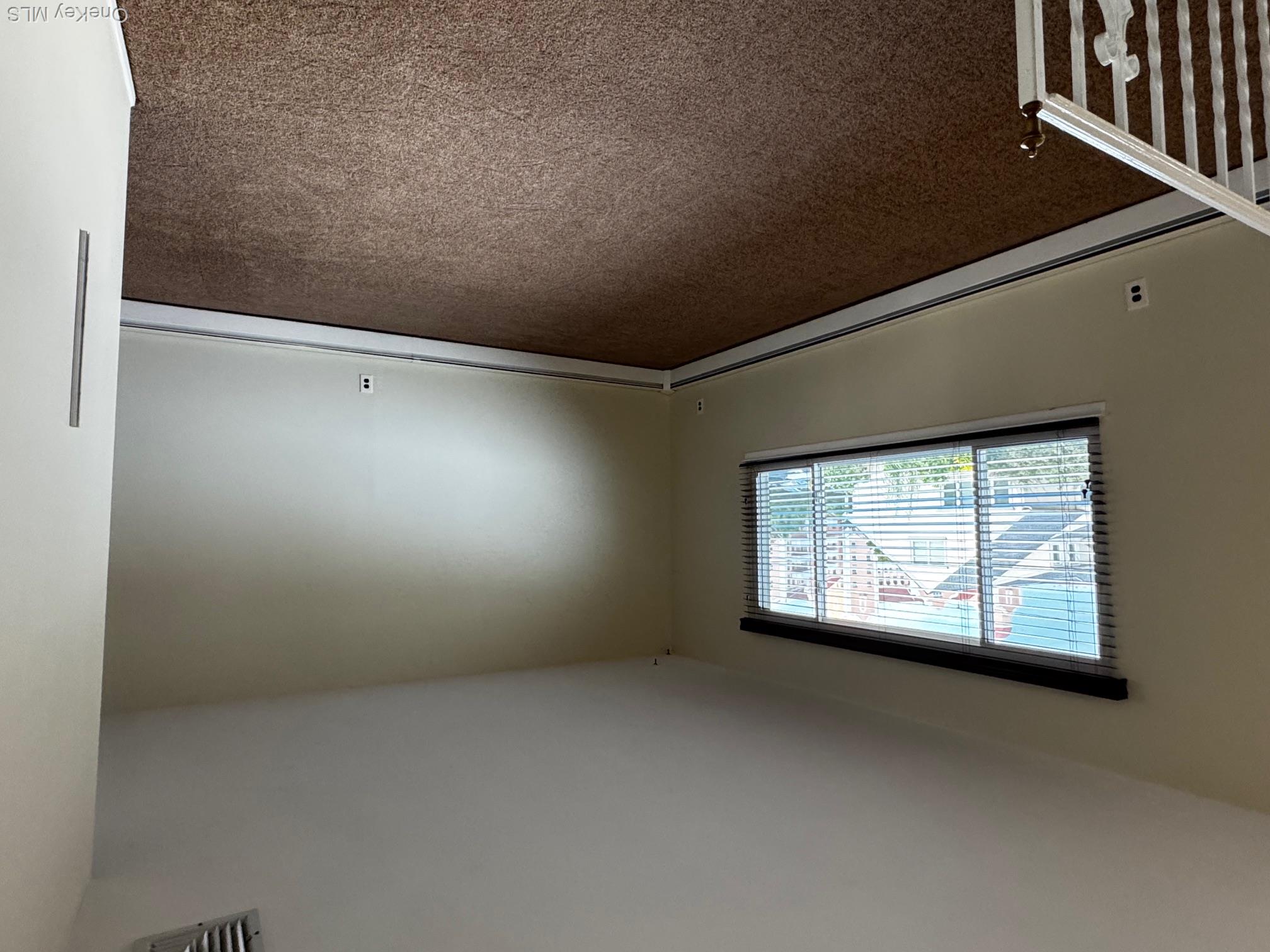 113 Maple Boulevard, Unit UPPR Long Beach, NY 11561 - Photo 3 of 11 an empty room with a window