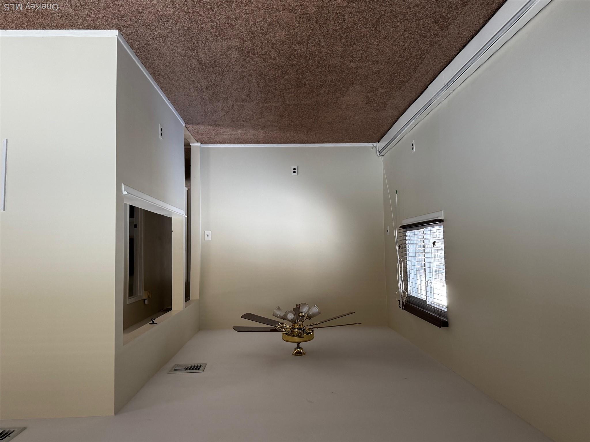113 Maple Boulevard, Unit UPPR Long Beach, NY 11561 - Photo 4 of 11 an empty room with windows and fan