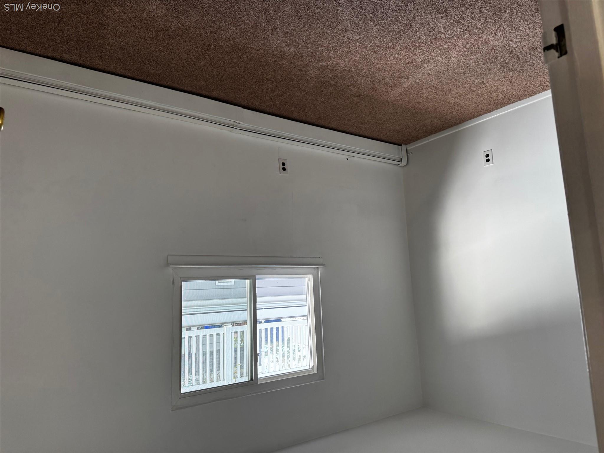 113 Maple Boulevard, Unit UPPR Long Beach, NY 11561 - Photo 6 of 11 an empty room with a window