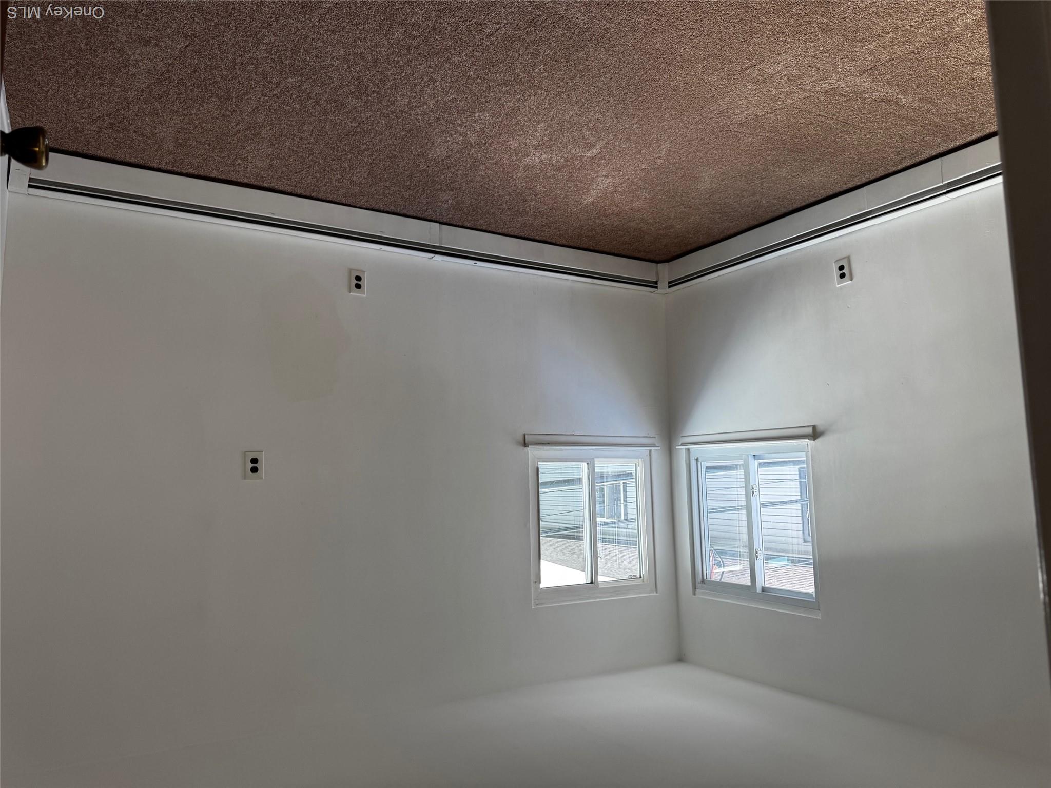 113 Maple Boulevard, Unit UPPR Long Beach, NY 11561 - Photo 7 of 11 an empty room with windows