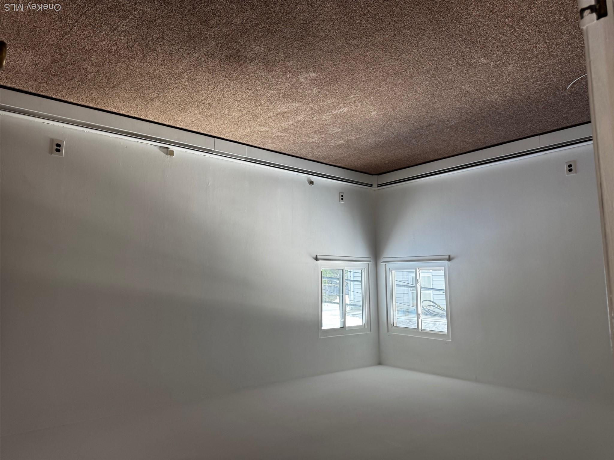113 Maple Boulevard, Unit UPPR Long Beach, NY 11561 - Photo 9 of 11 an empty room with a window