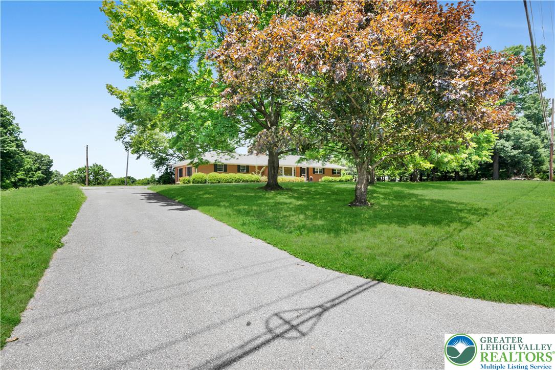 5747 Kernsville Road Orefield, PA 18069 - Photo 49 of 56 a view of a street with a big yard and large trees