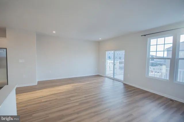 a view of kitchen with wooden floor and electronic appliances
