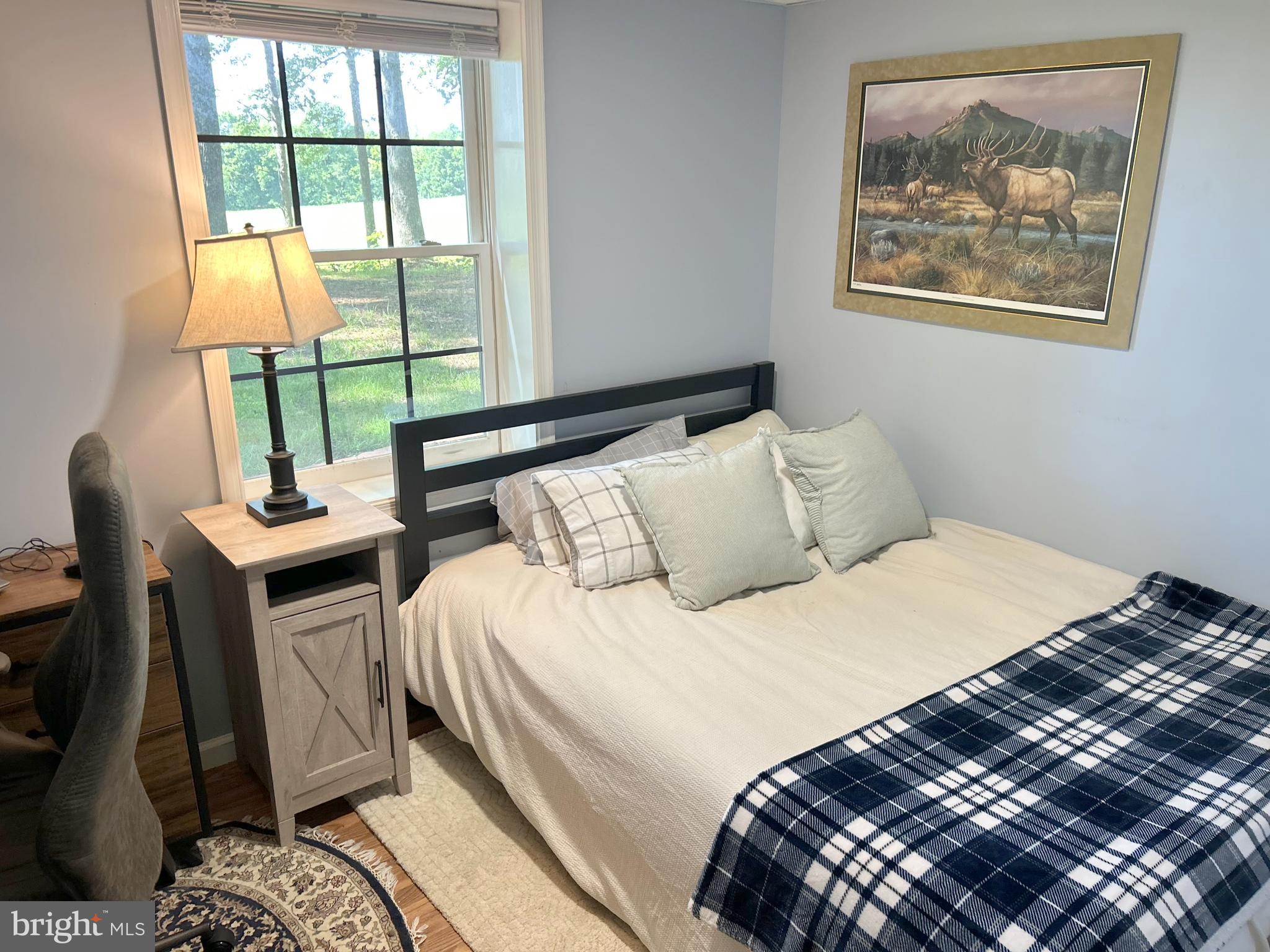 1425 Jacks Shop Road Rochelle, VA 22738 - Photo 34 of 56 a bedroom with a bed and a painting on the wall