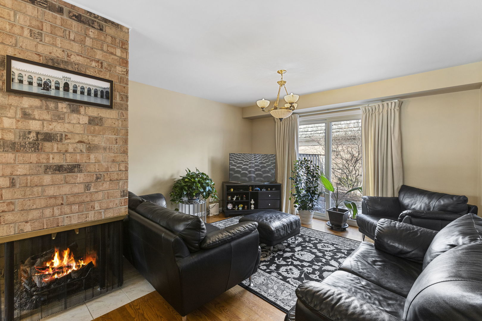 Undisclosed Address Oak Brook, IL 60523 - Photo 4 of 18 a living room with furniture a fireplace and a floor to ceiling window