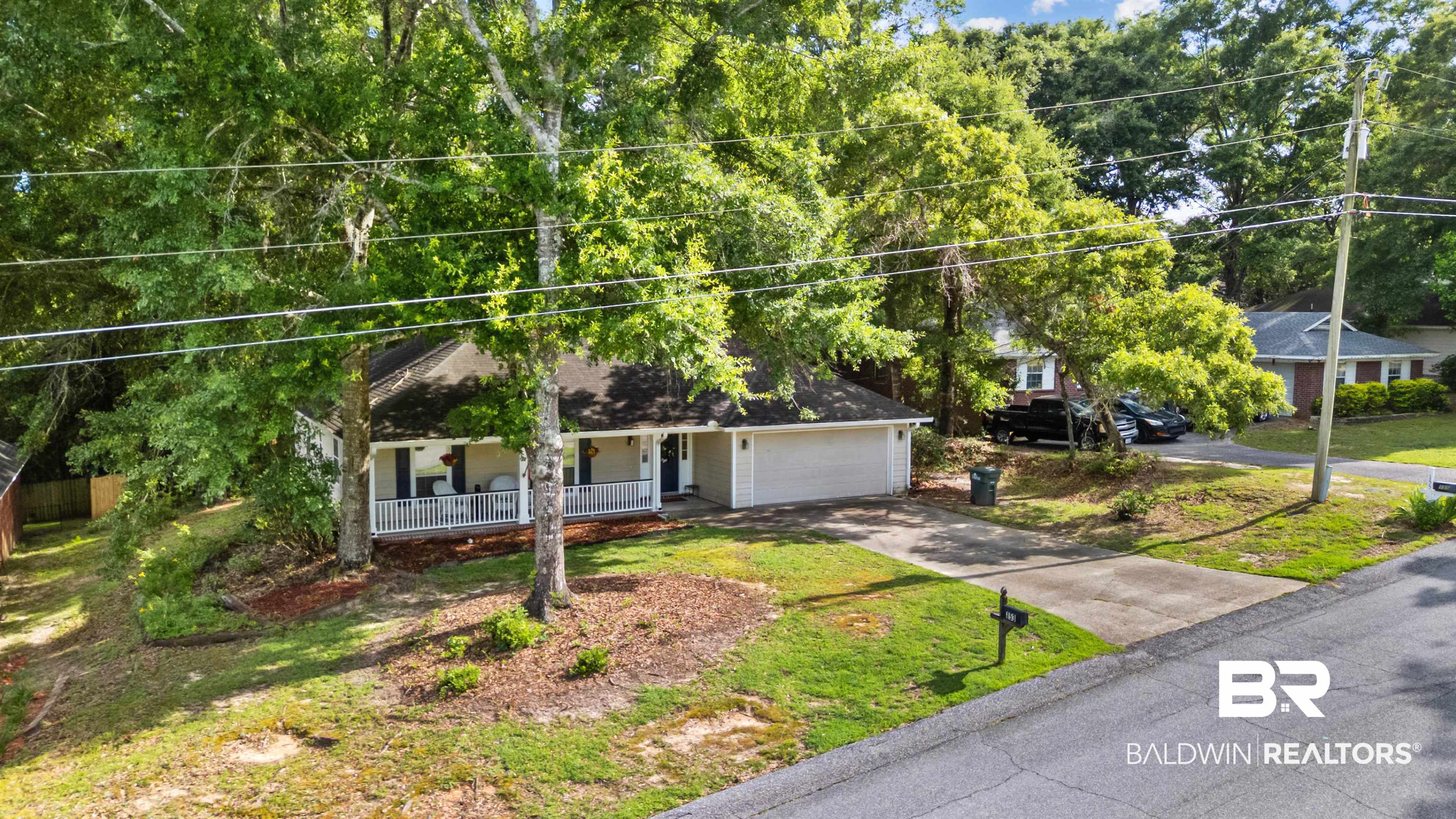 153 Lakeview Loop Daphne, AL 36526 - Photo 4 of 56 Thoughtfully positioned among mature landscaping, this home blends privacy, comfort, and neighborhood charm.
