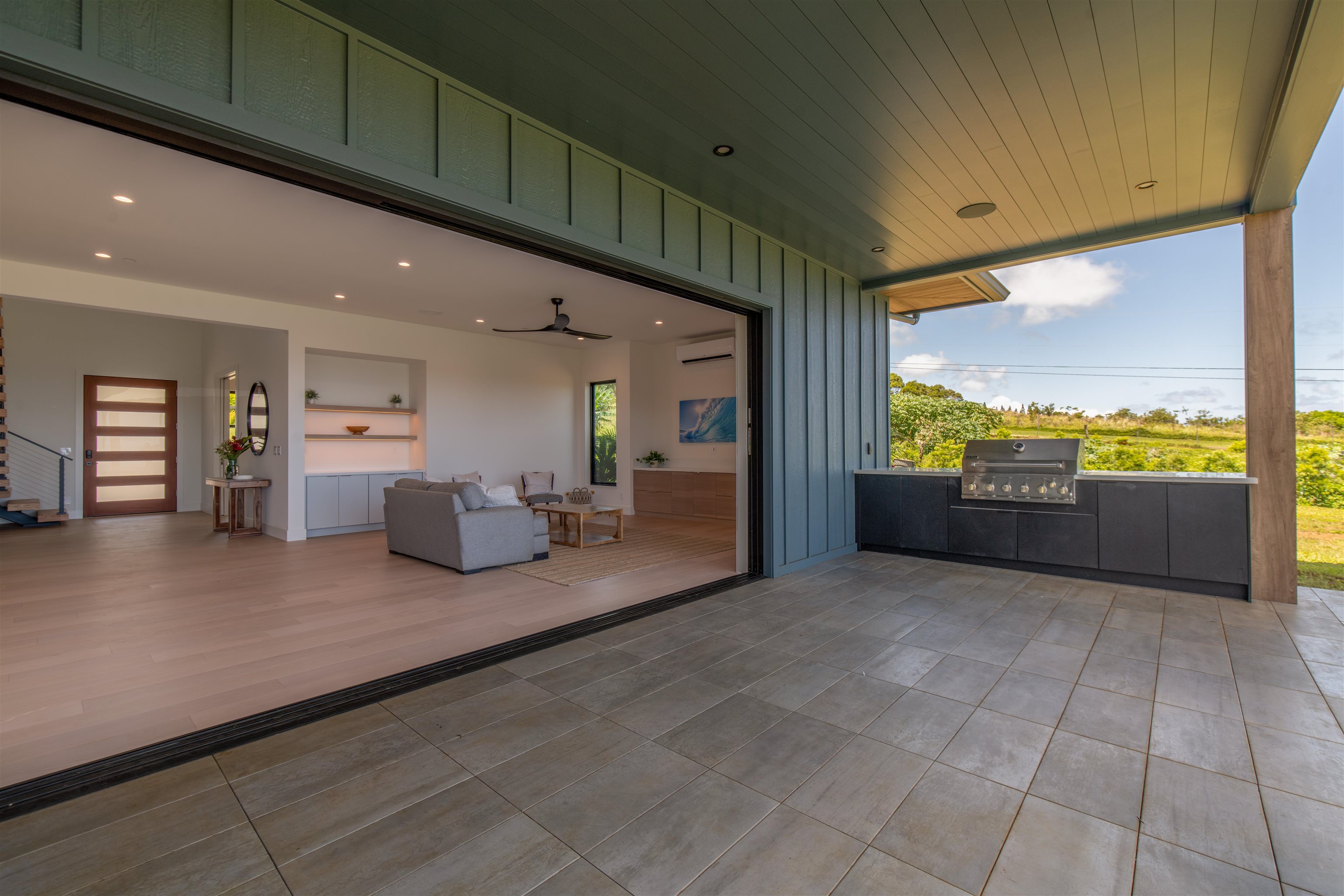 111 Mehana Road, Unit A Haiku, HI 96708 - Photo 8 of 50 a living room with furniture and a floor to ceiling window