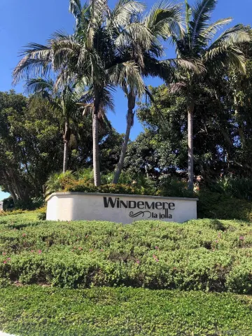a view of a house with a yard and potted plants