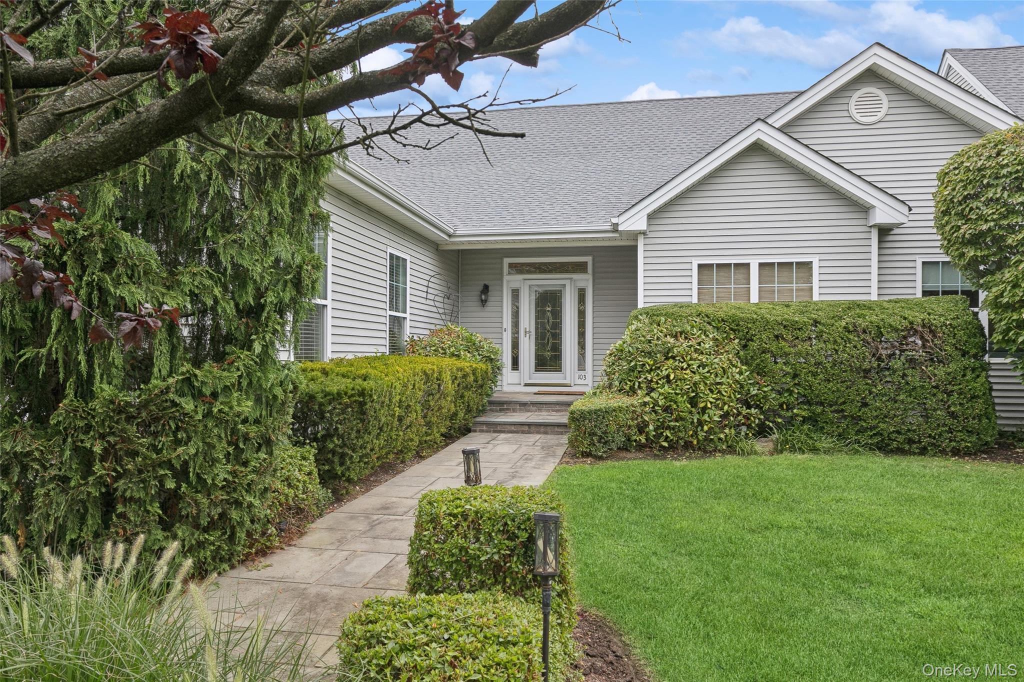 View of front of house with roof with shingles and a front lawn