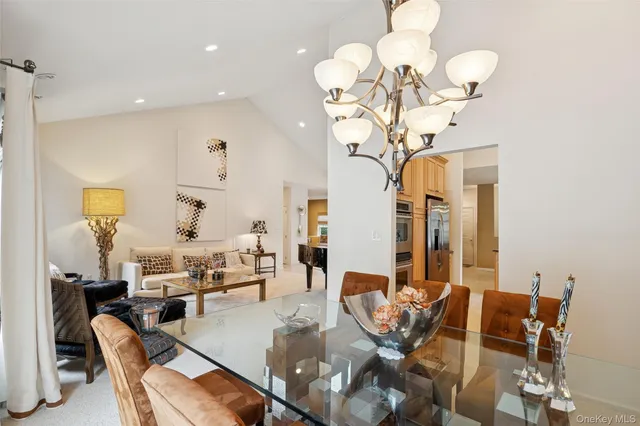 a view of a dining room with furniture and chandelier