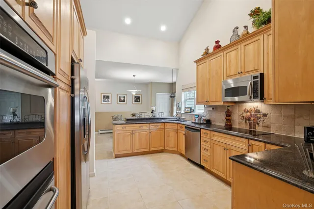 a kitchen with granite countertop a sink and stainless steel appliances