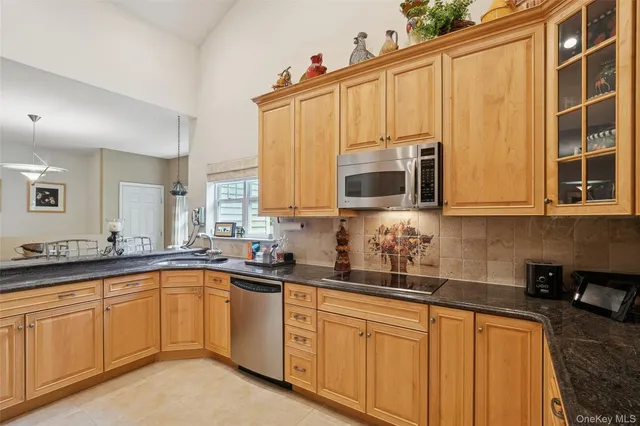 a kitchen with stainless steel appliances a sink dishwasher stove and cabinets