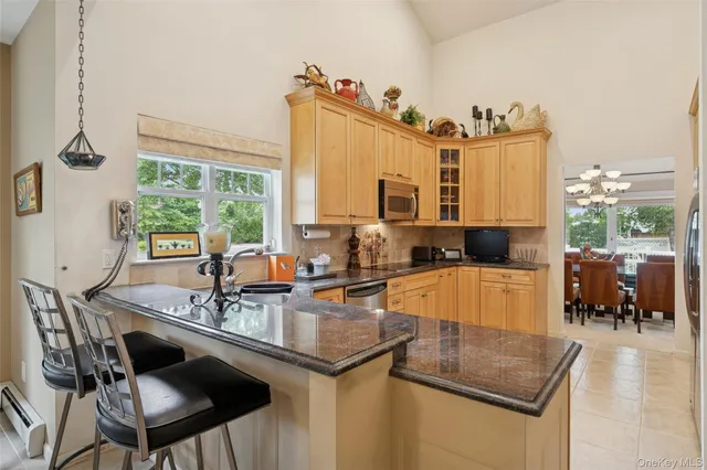 a kitchen with a sink stove and chairs