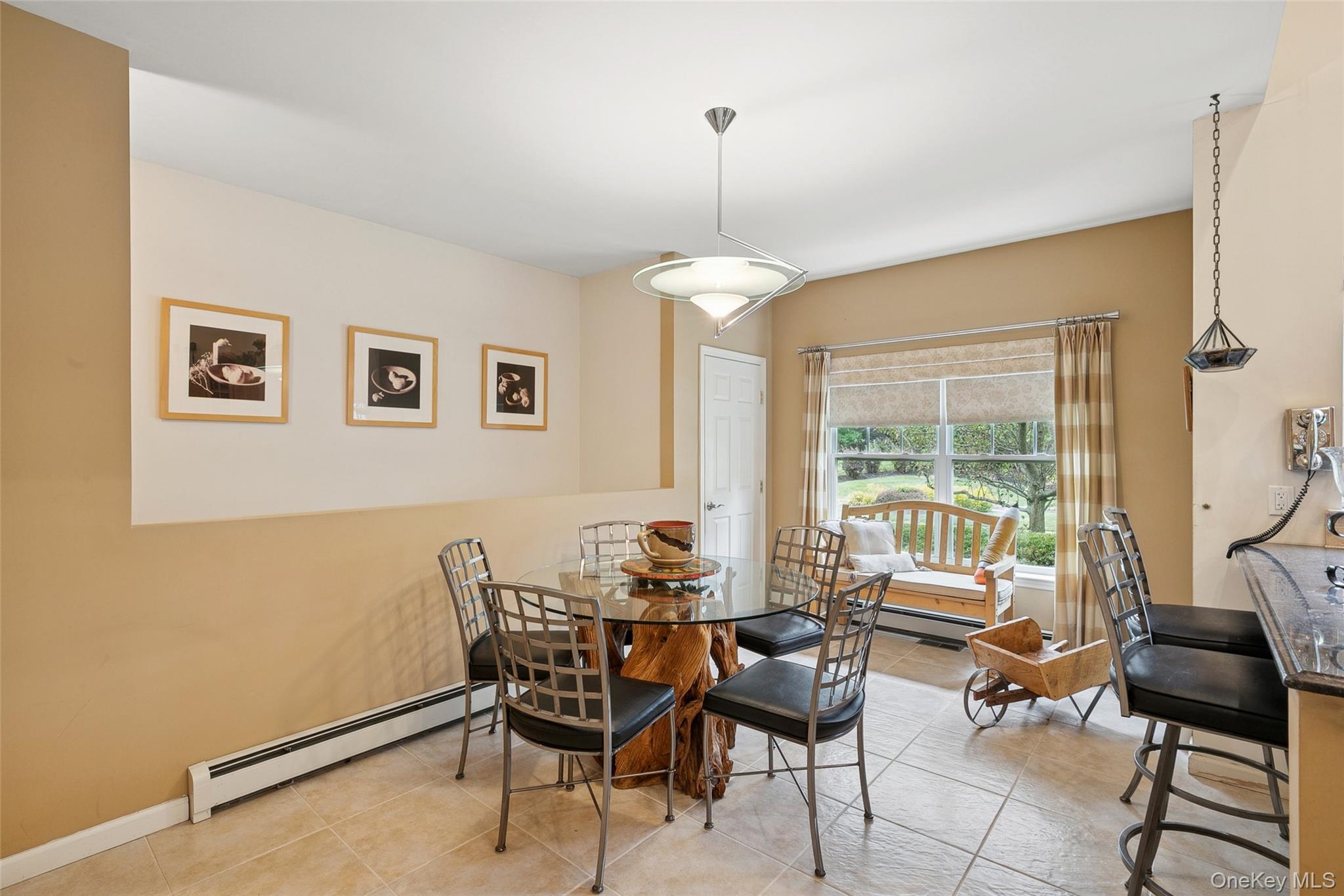 103 Rivendell Court Melville, NY 11747 - Photo 16 of 47 Dining area with a baseboard heating unit and light tile patterned floors