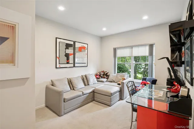 a living room with furniture a window and a flat screen tv