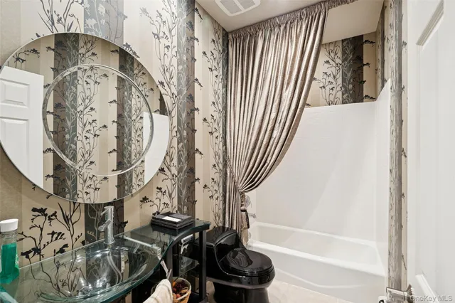 a bathroom with a bathtub and shower