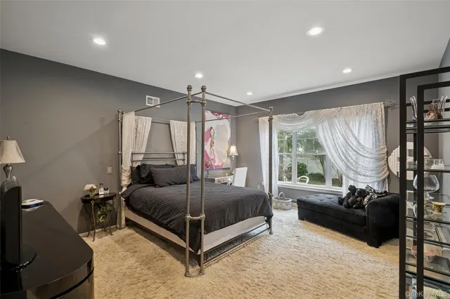 a bedroom with a bed couch and window