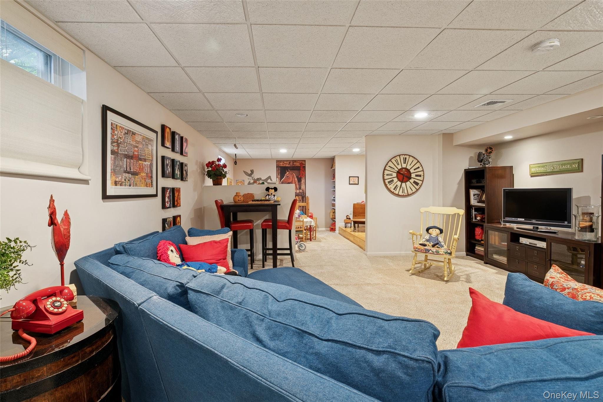 103 Rivendell Court Melville, NY 11747 - Photo 30 of 47 Carpeted living room featuring a paneled ceiling and baseboards