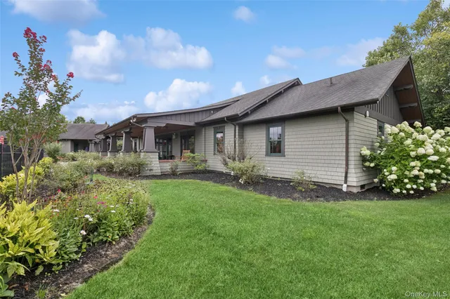 a front view of house with a garden