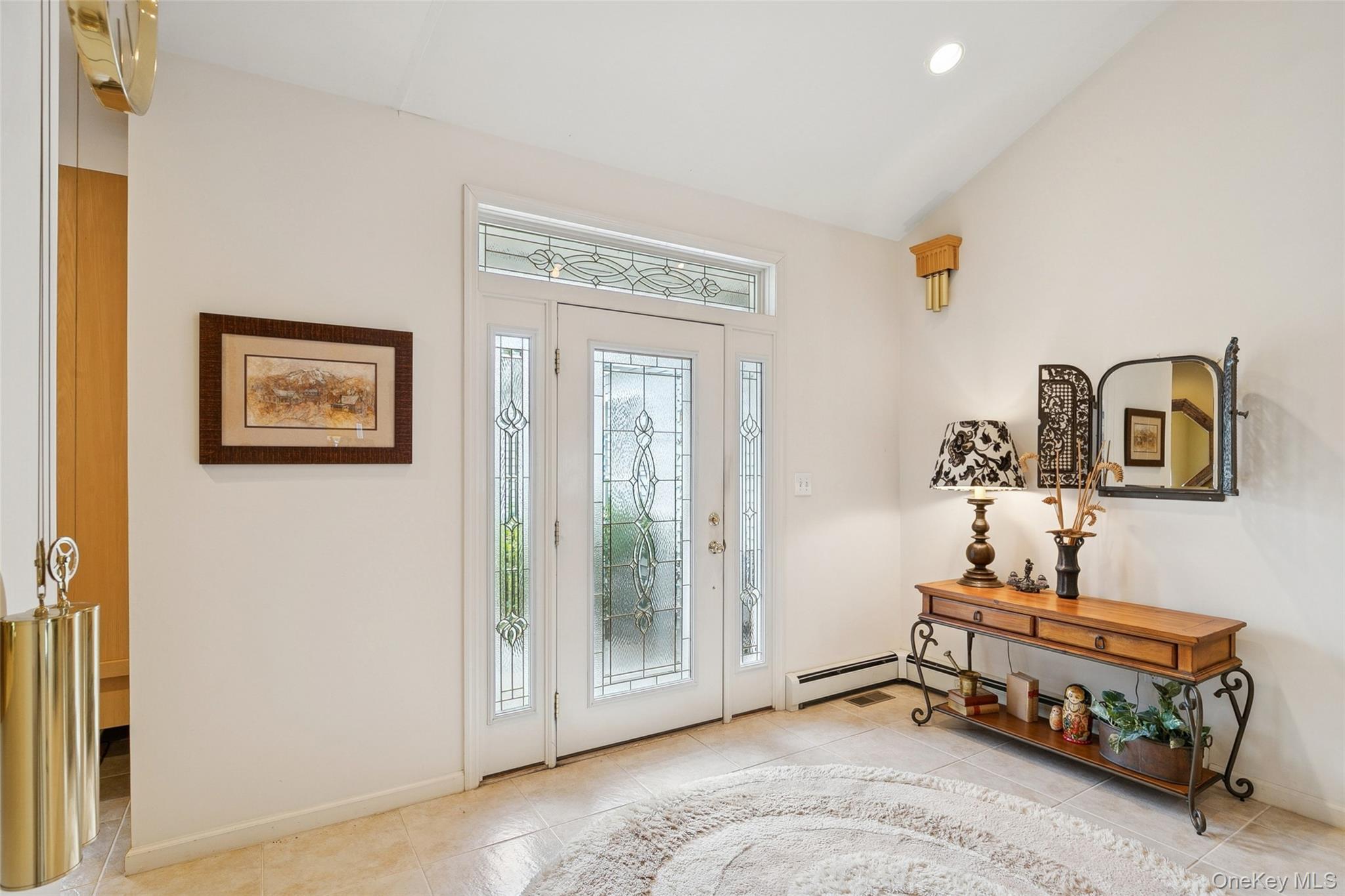 103 Rivendell Court Melville, NY 11747 - Photo 4 of 47 Foyer entrance featuring vaulted ceiling, recessed lighting, and light tile patterned floors
