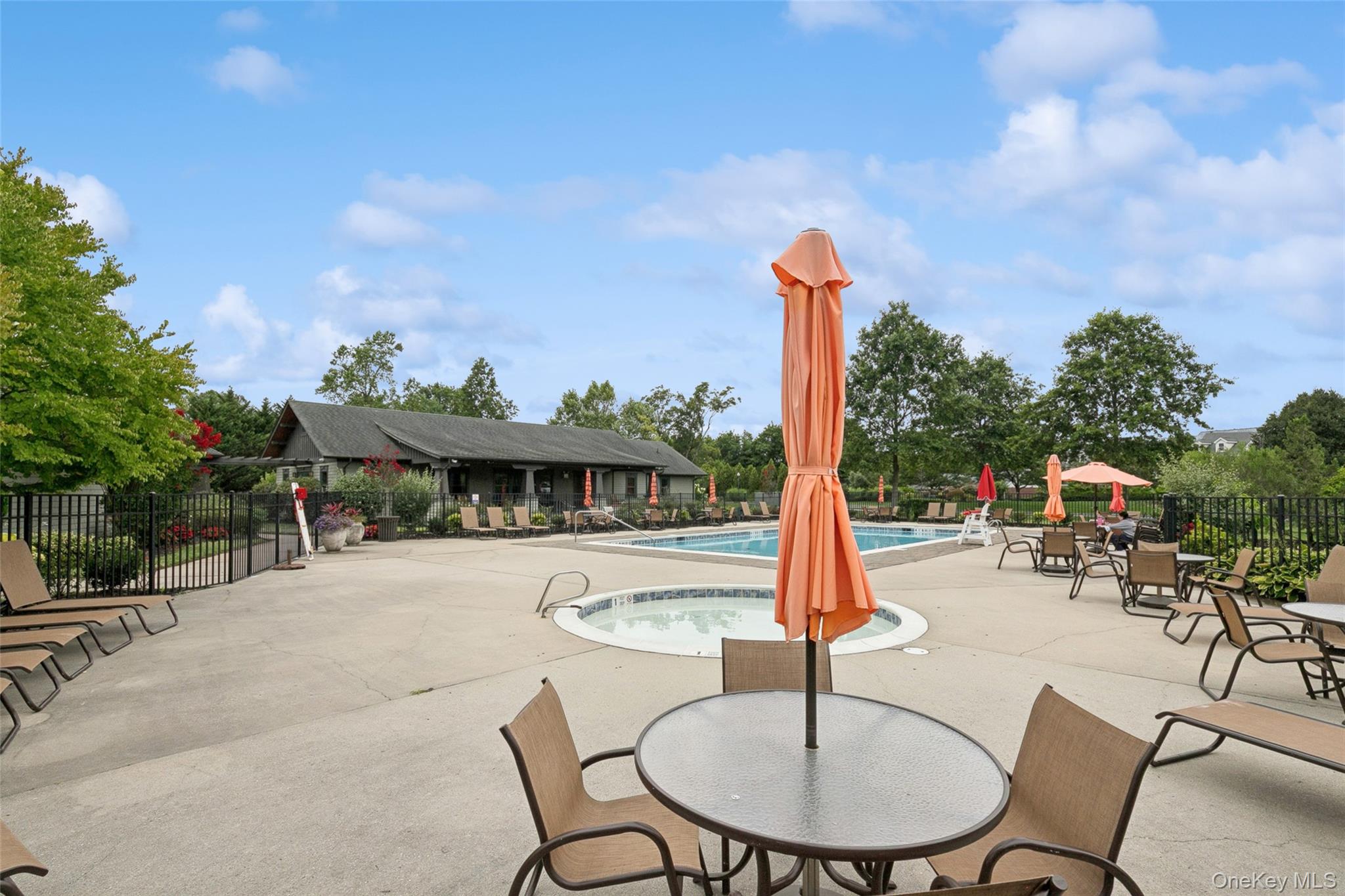 103 Rivendell Court Melville, NY 11747 - Photo 42 of 47 Community pool featuring a patio, a community hot tub, and outdoor dining space
