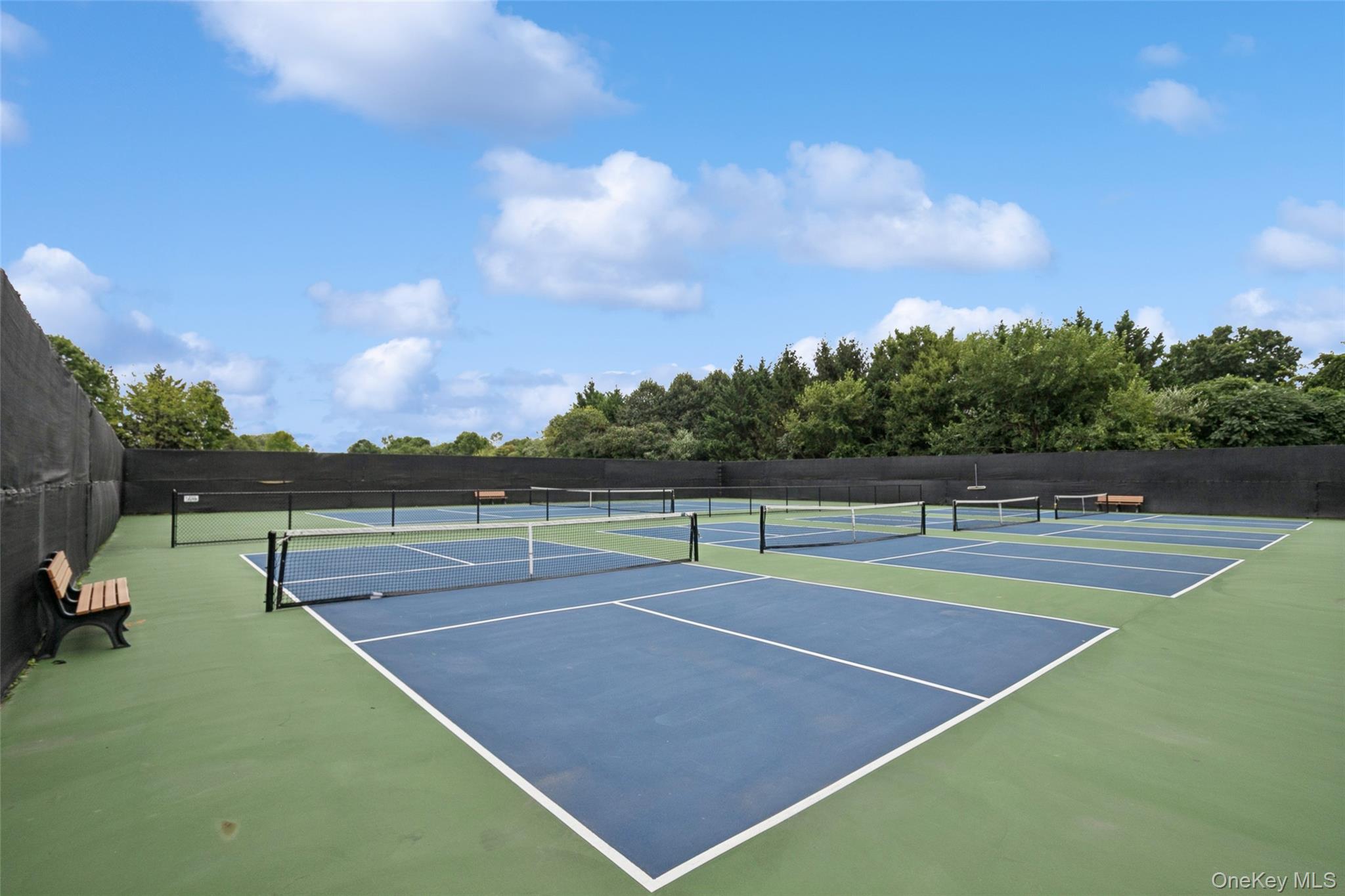 103 Rivendell Court Melville, NY 11747 - Photo 43 of 47 View of tennis court featuring community basketball court and view of wooded area