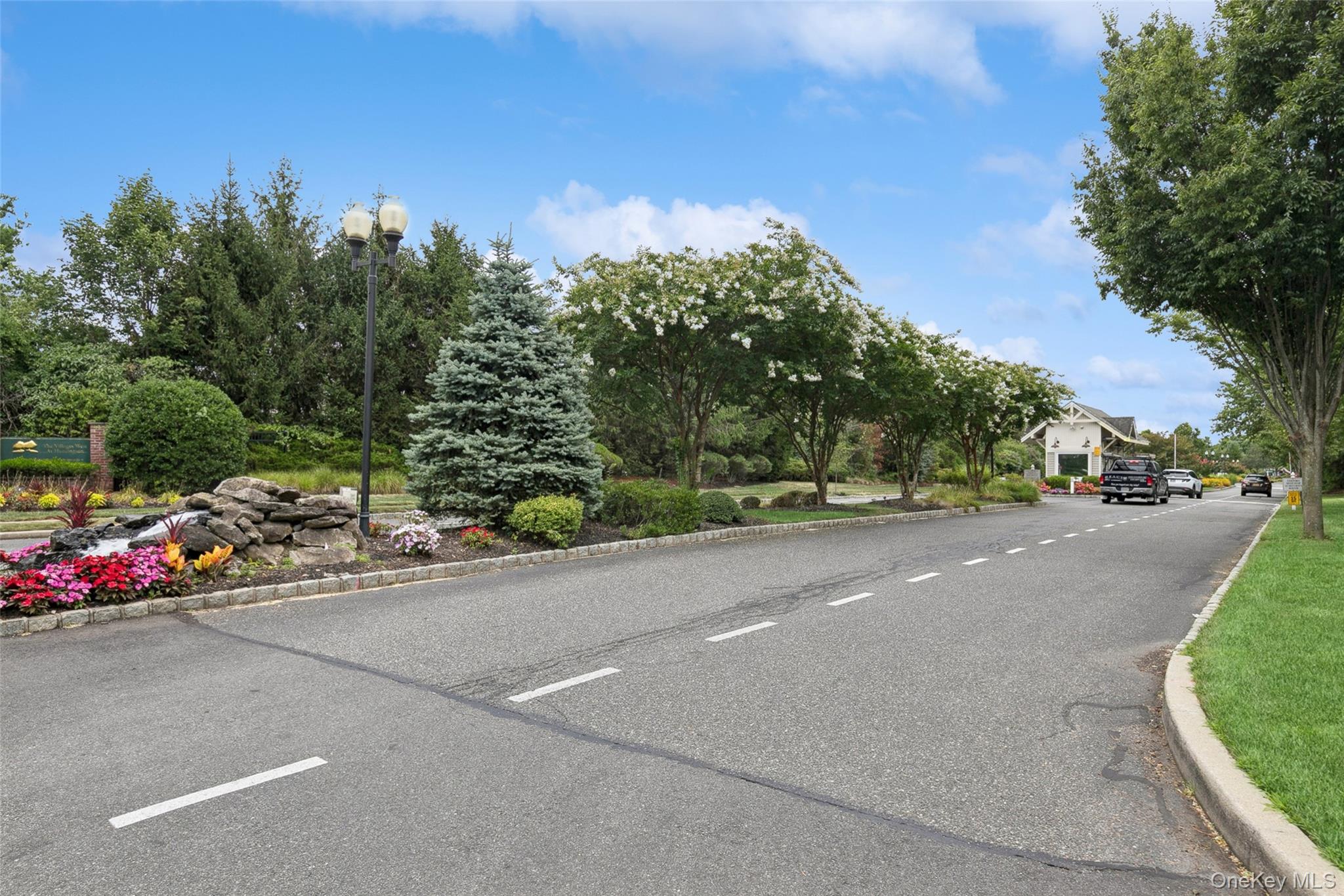 103 Rivendell Court Melville, NY 11747 - Photo 47 of 47 View of asphalt road featuring curbs and street lights