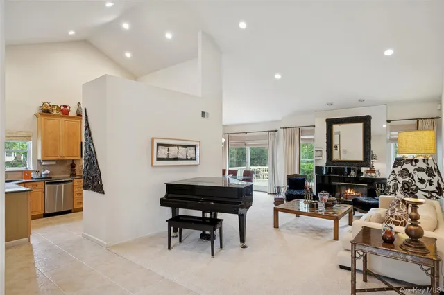 a living room with furniture a rug and a large window