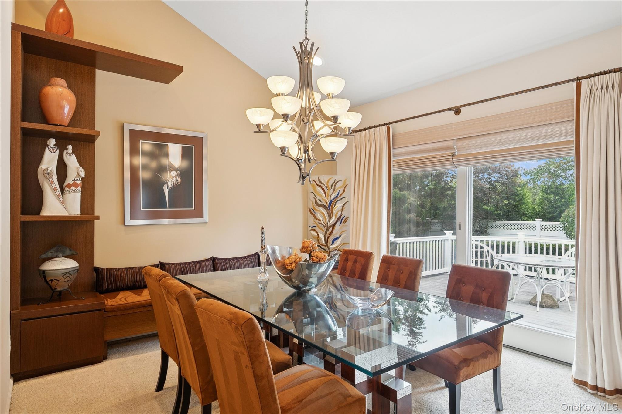 103 Rivendell Court Melville, NY 11747 - Photo 10 of 47 Dining area with light carpet, a chandelier, and lofted ceiling