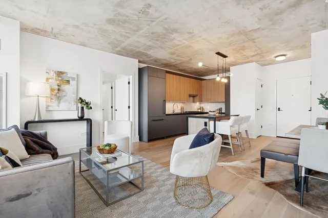 a living room with furniture and kitchen view