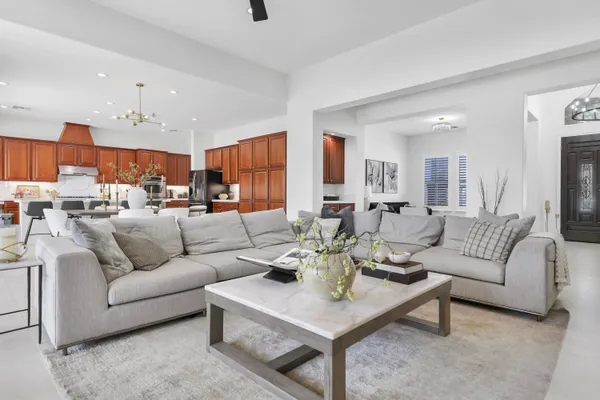 a living room with furniture kitchen and a table
