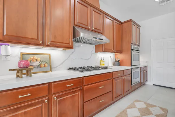 a kitchen with stainless steel appliances granite countertop a sink and cabinets