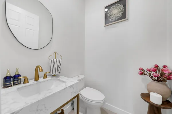 a bathroom with a toilet a sink and a mirror