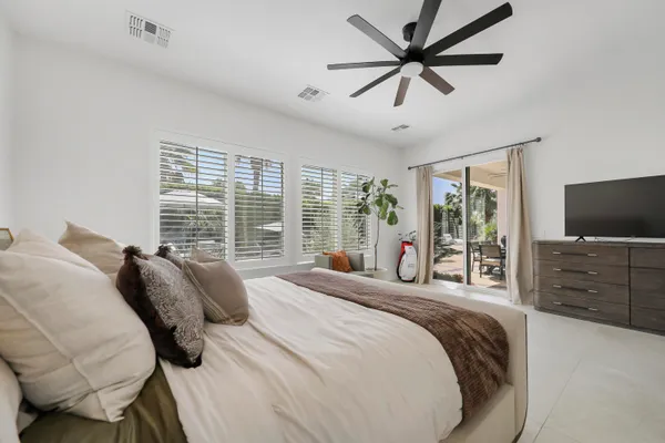 a bedroom with a bed and a flat screen tv