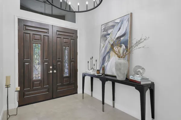 a view of a hallway with wooden floor and entryway