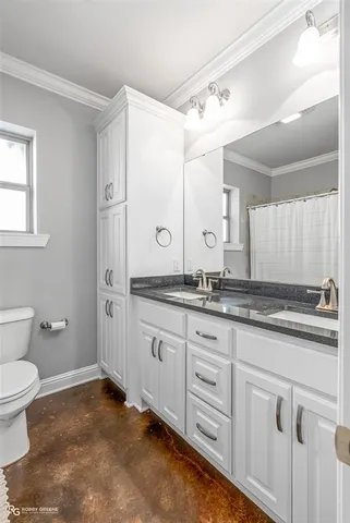 a bathroom with a granite countertop sink mirror and toilet