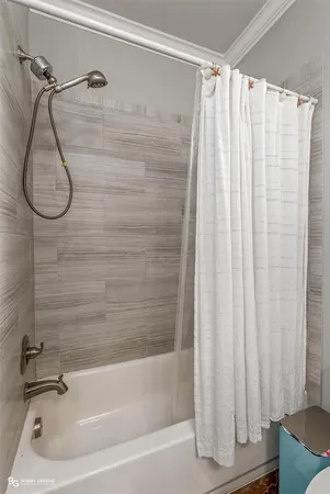 a bathroom with a shower and a bath tub