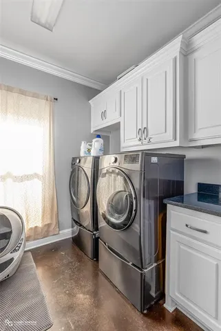 a utility room with sink dryer and washer