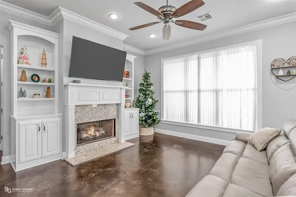 a living room with furniture a flat screen tv and a fireplace
