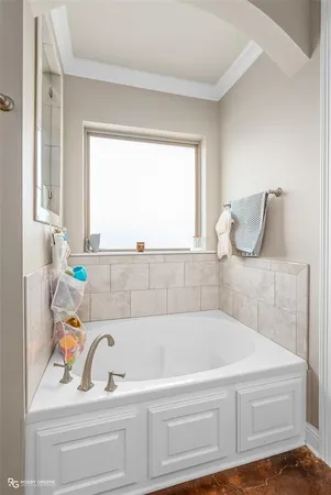 a bathroom with bathtub and window