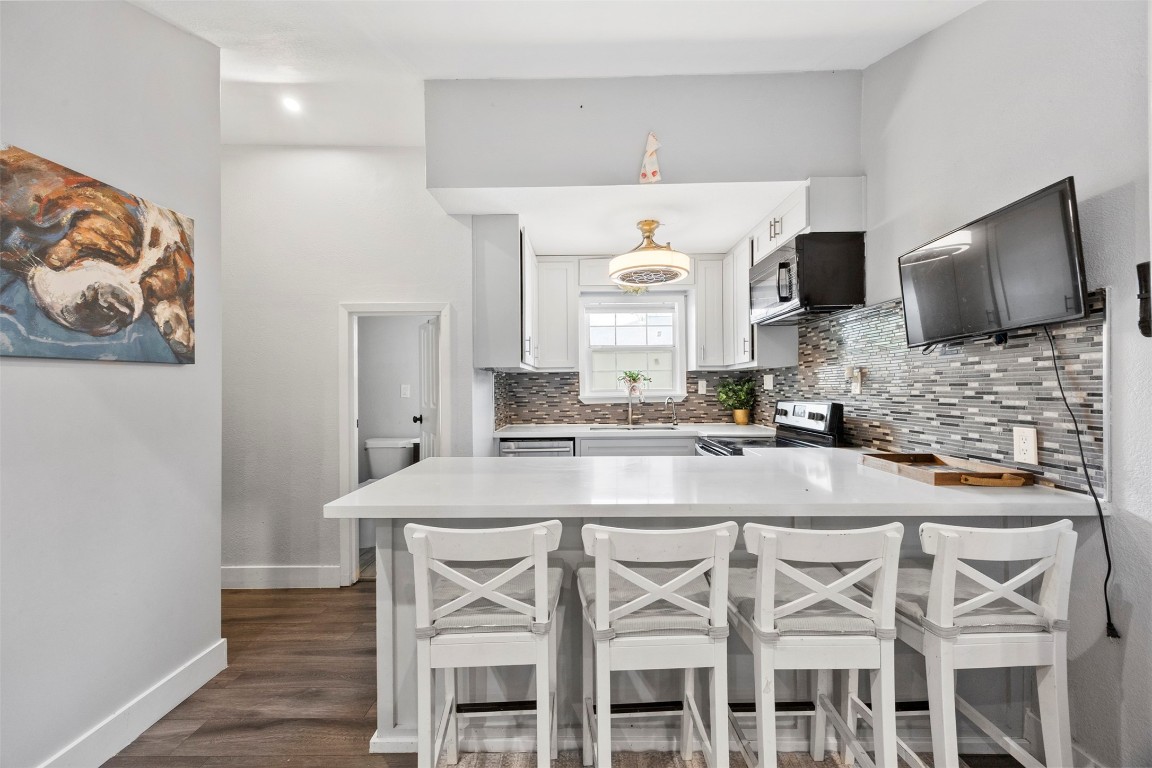 10430 Caxton Street Houston, TX 77016 - Photo 11 of 26 a kitchen with a table chairs sink and cabinets