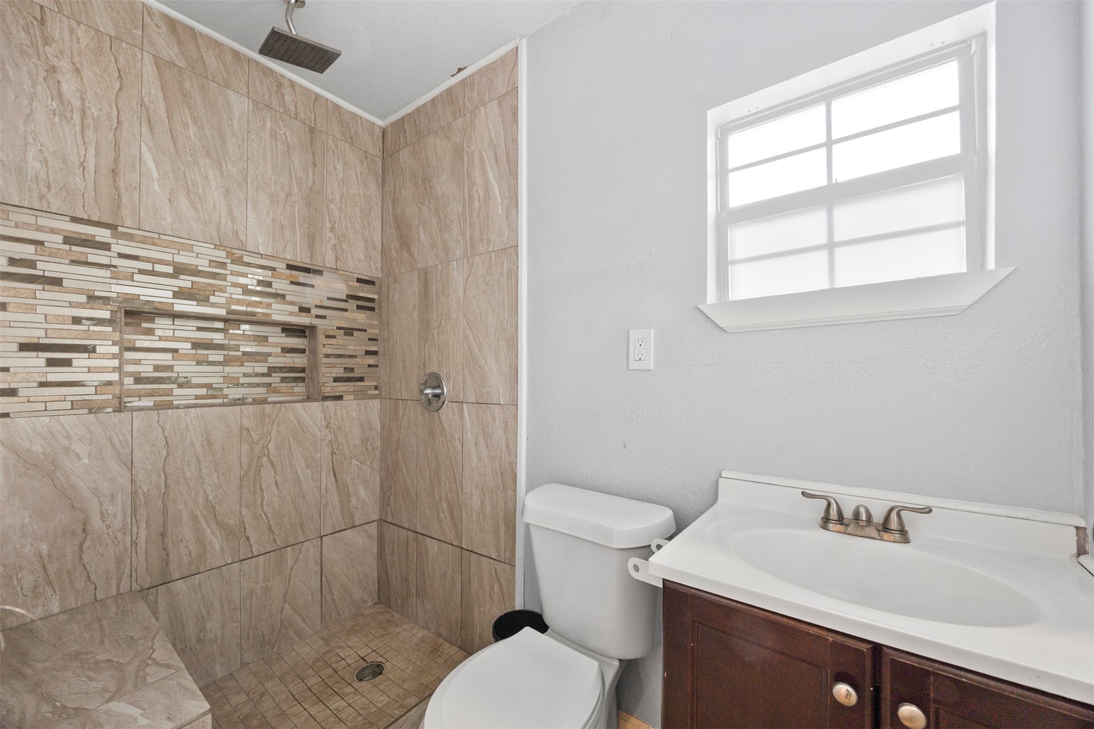 10430 Caxton Street Houston, TX 77016 - Photo 12 of 26 a bathroom with a sink toilet and shower