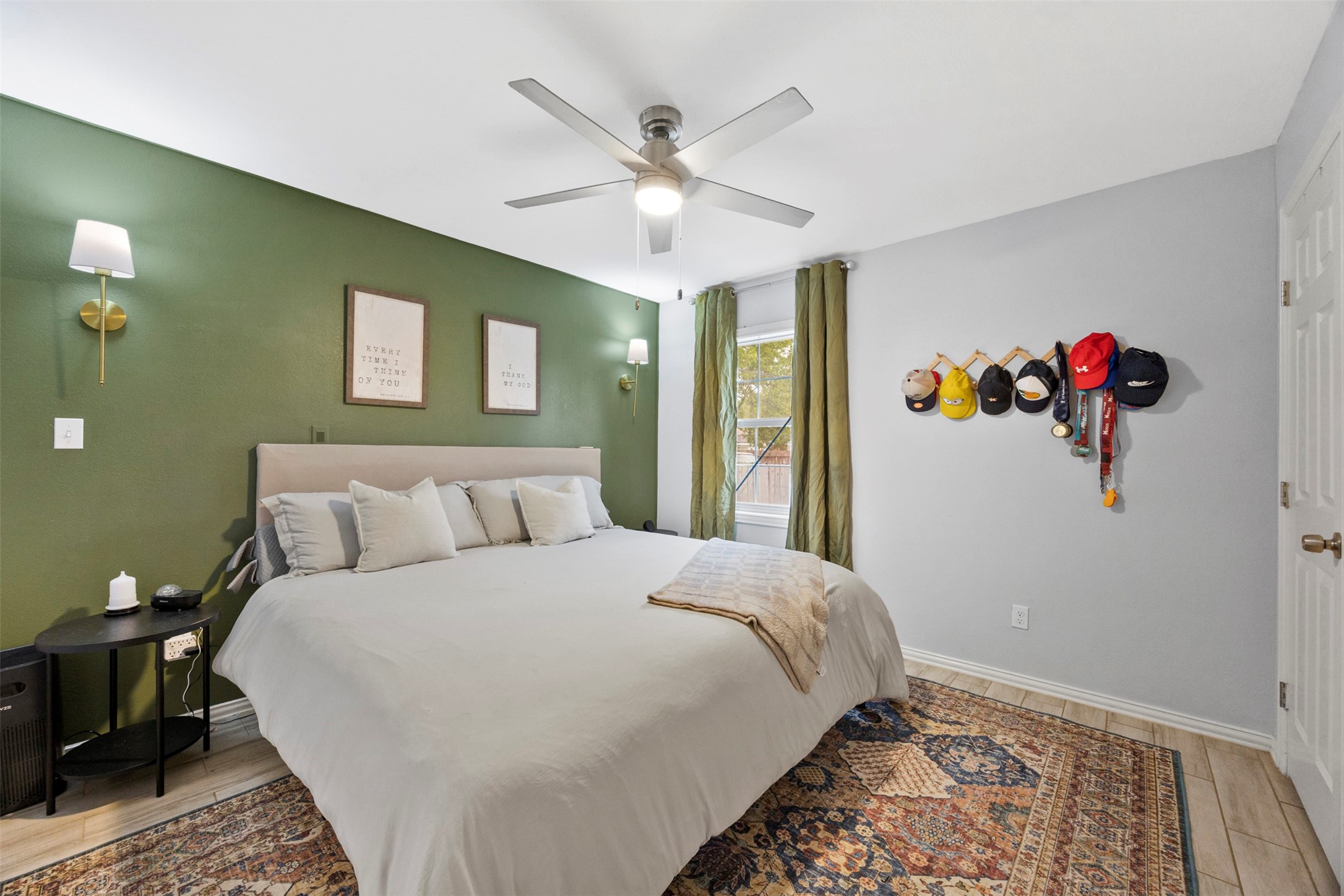 10430 Caxton Street Houston, TX 77016 - Photo 14 of 26 a bedroom with a bed and a chandelier