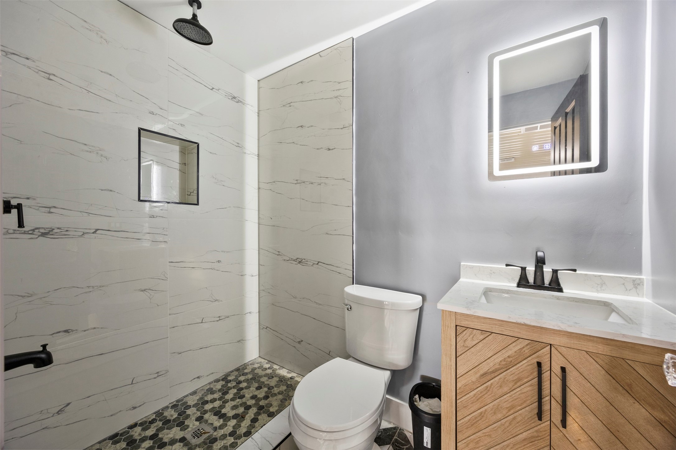 10430 Caxton Street Houston, TX 77016 - Photo 18 of 26 a white toilet sitting next to a bathroom sink