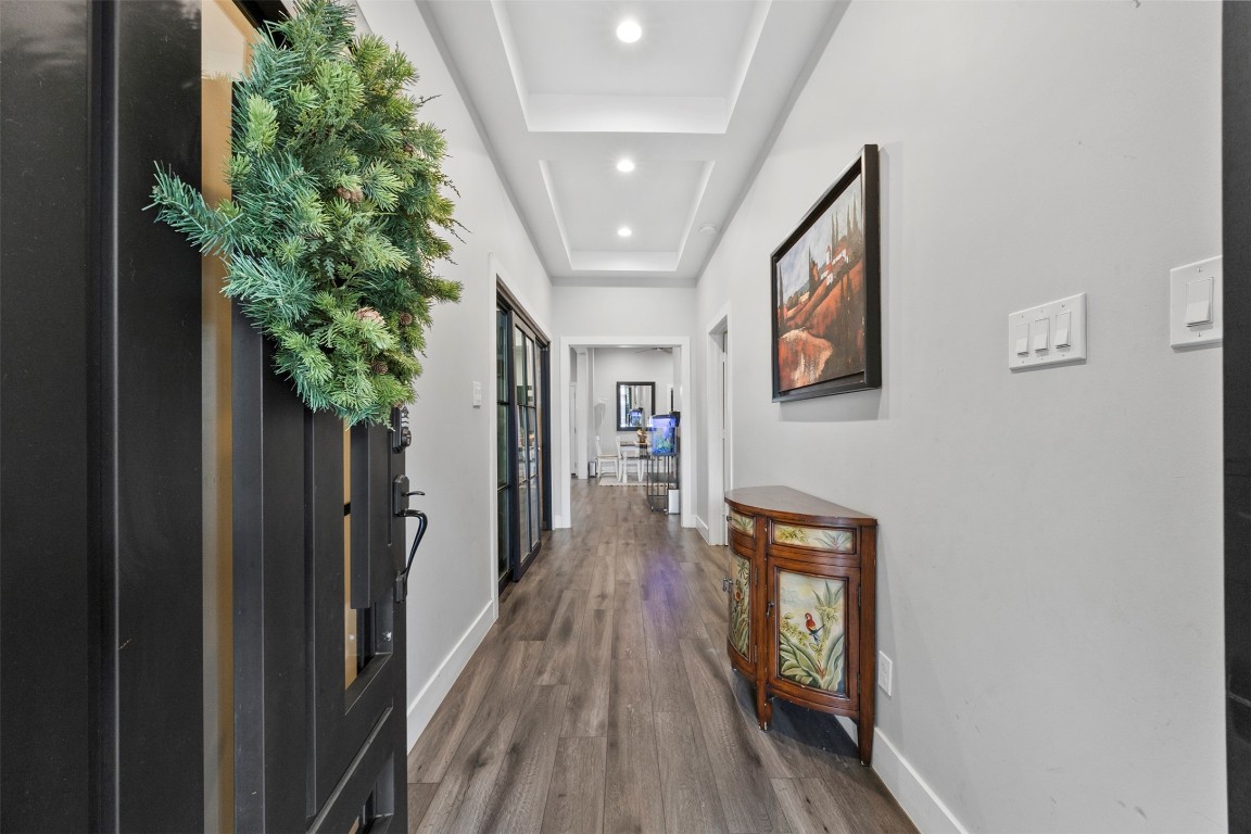 10430 Caxton Street Houston, TX 77016 - Photo 5 of 26 a hallway with wooden floor chandelier and entryway