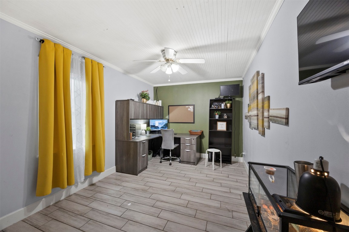 10430 Caxton Street Houston, TX 77016 - Photo 10 of 26 a bedroom with a bed and a chandelier