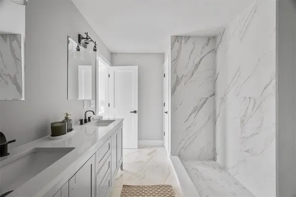 a bathroom with a double vanity sink and mirror