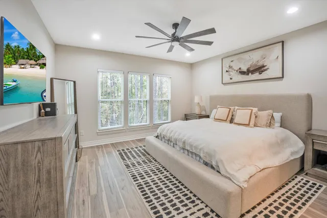 a bedroom with a large bed and a window